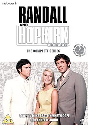 cover of sci-fi detective tv show with three people: a man and woman looking forward and another man glaring at the first man